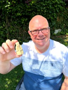 Gregory Hunt holding a carved Lewis-style chess bishop, symbolising the role of the specialist mediator in ADR - insightful, domain-focused, and precise.