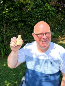 Gregory Hunt holding a carved Lewis-style chess king, representing the role of the disputing party in ADR - central but constrained.