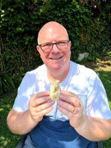 Gregory Hunt holding a carved Lewis-style chess queen, symbolising the flexible, dynamic role of the commercial mediator in ADR.